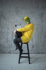 A man in a light yellow suit on top of a mask, considers it necessary