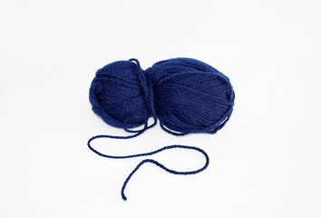 Ball of dark blue yarn for knitting and craft making, on white background.