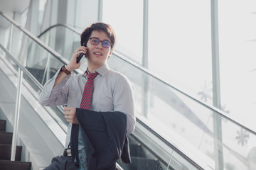 Handsome smiling confident businessman talking something on smart phone.