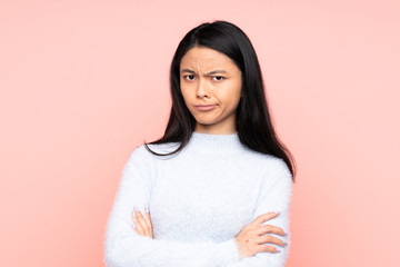 Teenager Chinese woman isolated on pink background feeling upset
