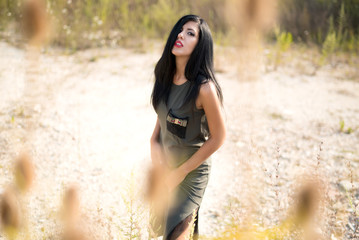 Beautiful woman enjoying the life in the field. Nature beauty, colorful field, fashion woman. Outdoor lifestyle. Freedom concept