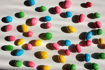 Colorful jelly beans background. Abstract background with candies. Harsh daylight with deep shadows