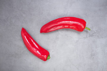 two red bell peppers on concrete background