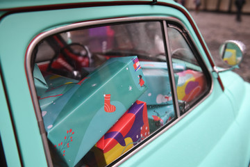 Fototapeta premium Small retro car full of gift boxes