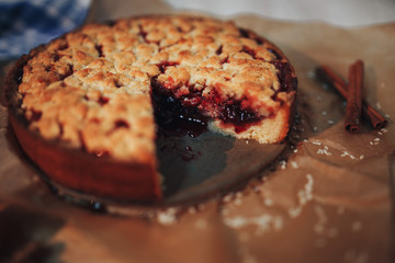 jam pie on kraft paper with a cut piece lying next to it on a plate