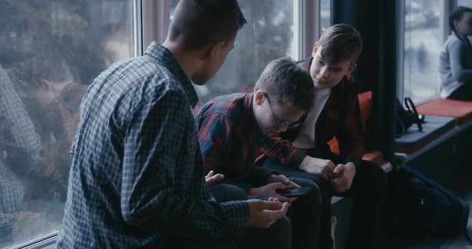 Boys bullying classmate in school corridor