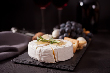 Camembert brie and mozarella cheese with honey and herbs. Dairy products.