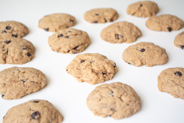 Homemade chocolate cookies in rows on a white background