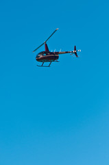 Fototapeta na wymiar Front, bottom view of a comercial helicopter, , flying of tropical beach on gulf of mexico on a sunny, winter day
