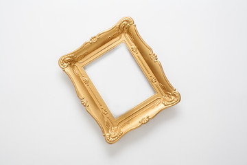 Gold photo frame in vintage style, located on a white background. A conceptual frame for registration of certificates, awards and diplomas, or a stylish design of any subject.