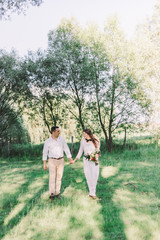 stylish bride and groom in the garden. a groom with a beard. fan art. rustic style