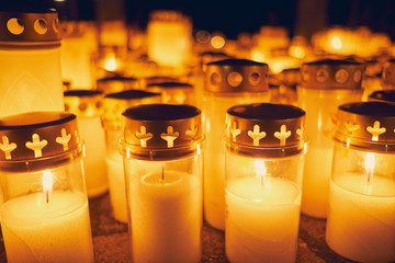 Many candles kindling at a cemetery on All Saints' Day