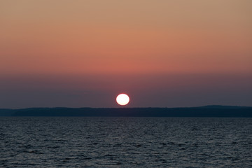 Red sunrise over lake