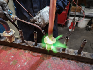 Soldering of brass fittings on copper pipe.