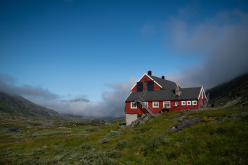 Stavali mountain cabin in Hardanguervidda National Park with morning haze on a summer day.