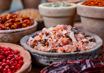 Indian spices collection, sea and rock salt mixed with red hot chili peppers and another spices in clay bowls