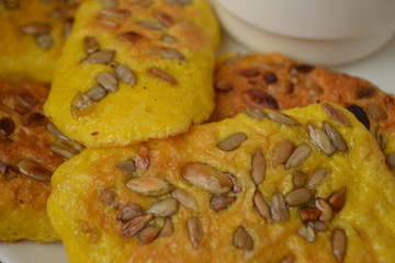 Egg yellow pancakes with seeds on a plate.