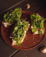 homemade bread bruschettas with raw ham and arugula salt and garlic