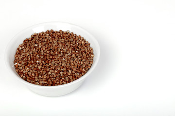 buckwheat in a white plate on a white background