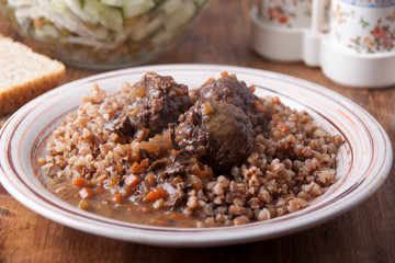   Meatballs in sauce with buckwheat garnish