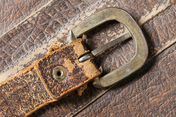 Cloesup of a leather handbag with a belt buckle