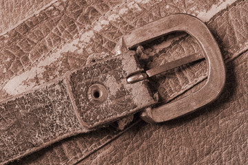 Cloesup of a leather handbag with a belt buckle