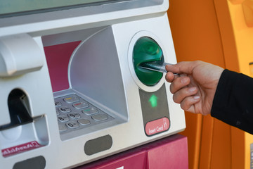 Woman's hand using Credit Card to withdrawing or transfer money from Atm machine.Finance, money,...