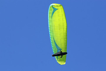 Paraglider flying wing in a blue sky	
