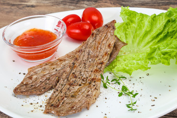 Grilled Thick pork steak served salad