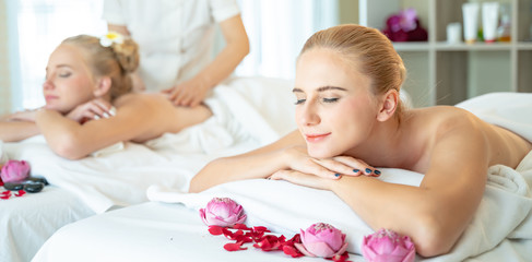 Concept of traditional thai massage relax and body health care .Beautiful caucasian woman getting back and shoulder massage in spa salon.blonde beautiful girl enjoying a massage at the health spa.