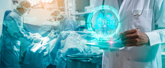 Doctor or Surgeon analyzing covid-19 to patient lungs testing result and human anatomy on technological digital futuristic virtual interface.Doctor with virtual reality in operation room in hospital.