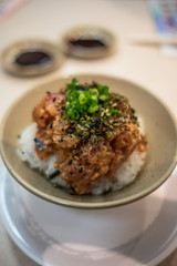 Close up of Spicy Salmon Rice Bowl - furikake over rice