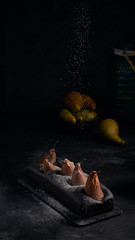 Vegan brownie chocolate loaf cake with pear autumn homemade baked pastry dessert gourmet food on black background.