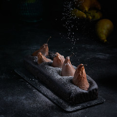 Vegan brownie chocolate loaf cake with pear autumn homemade baked pastry dessert gourmet food on black background.