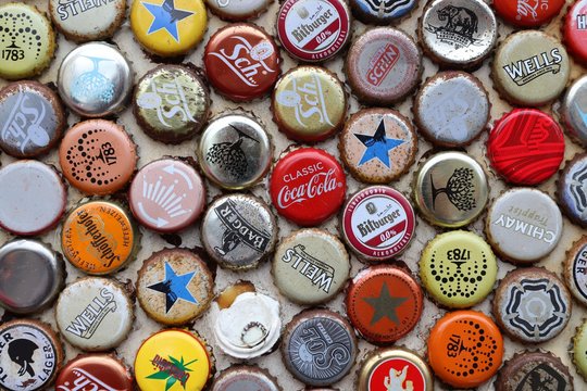 LONDON, UK - JULY 13, 2019: Mixed Beer And Non Alcoholic Beverages Metal Bottle Caps In London UK.
