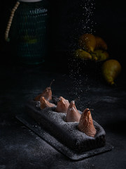 Vegan brownie chocolate loaf cake with pear autumn homemade baked pastry dessert gourmet food on black background.