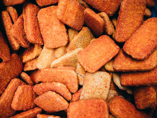 Many frozen cutlets in the supermarket refrigerator. Texture, background.
