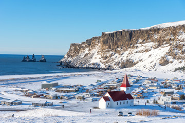 Picturesque aerial  view of Vik I Myrdal church at the top of the hill in Iceland in winter. Panoramic beautiful view of village Vik and Myrdal church in winter in Iceland 