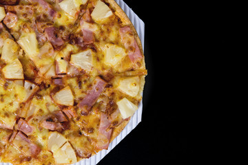 Sliced Hawaiian pizza.