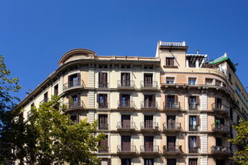 Fototapeta premium View of traditional, historical, typical residential buildings in Barcelona showing Spanish / Catalan architectural style. It is a sunny summer day.