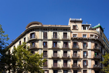 Fototapeta na wymiar View of traditional, historical, typical residential buildings in Barcelona showing Spanish / Catalan architectural style. It is a sunny summer day.
