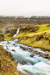 Waterfall in winter, Reyoarfjorour fjord, Iceland.