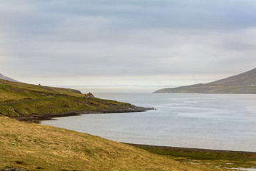 Waterfall in winter, Reyoarfjorour fjord, Iceland.