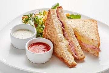 sandwiches with fresh salad on plate isolated on white background