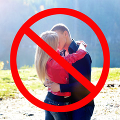 Kissing is dangerous. Great risk of infection. Prohibition sign for close contacts between people