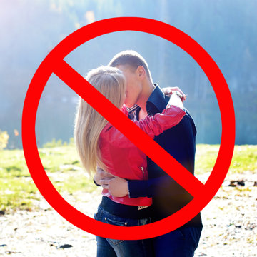 Kissing is dangerous. Great risk of infection. Prohibition sign for close  contacts between people Stock Photo | Adobe Stock