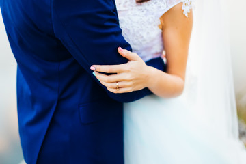 Close-up of hugging newlyweds. on the fingers of the bride a gol © Ivan
