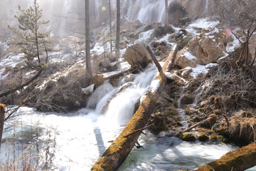 frozen waterfall with mossy rocks in a national park in Sichuan, China