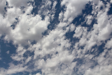 View of cloudy blue sky background.