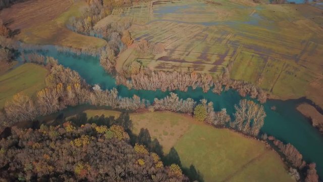 Blue Autumn Swampy River. Swampy Landscape Matica River. Aerial Footage of a Swampy River and Green Flooded Fields From a Bird's Eye View. Rijeka Matica kod Luznice Komani